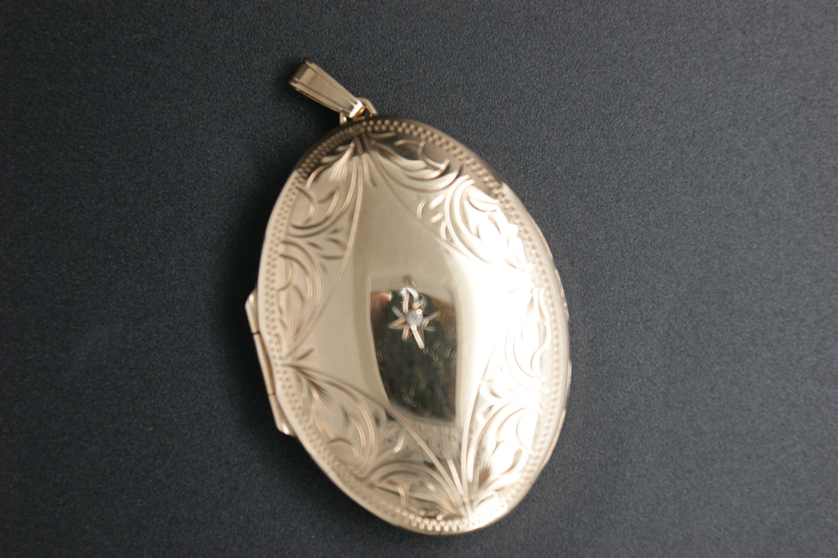 037- 9ct Gold Engraved Oval Locket with Star-set Diamond.