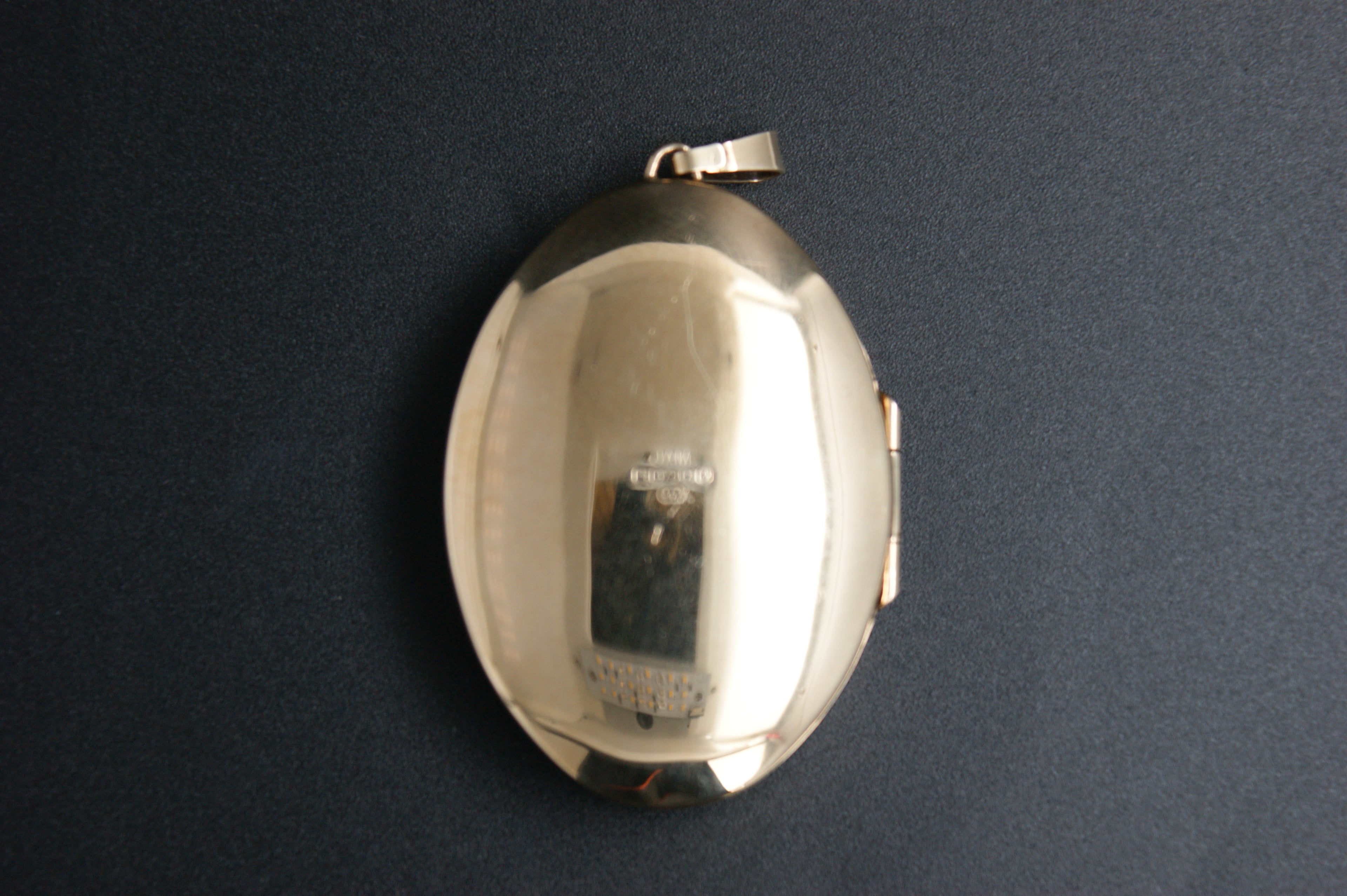 037- 9ct Gold Engraved Oval Locket with Star-set Diamond.