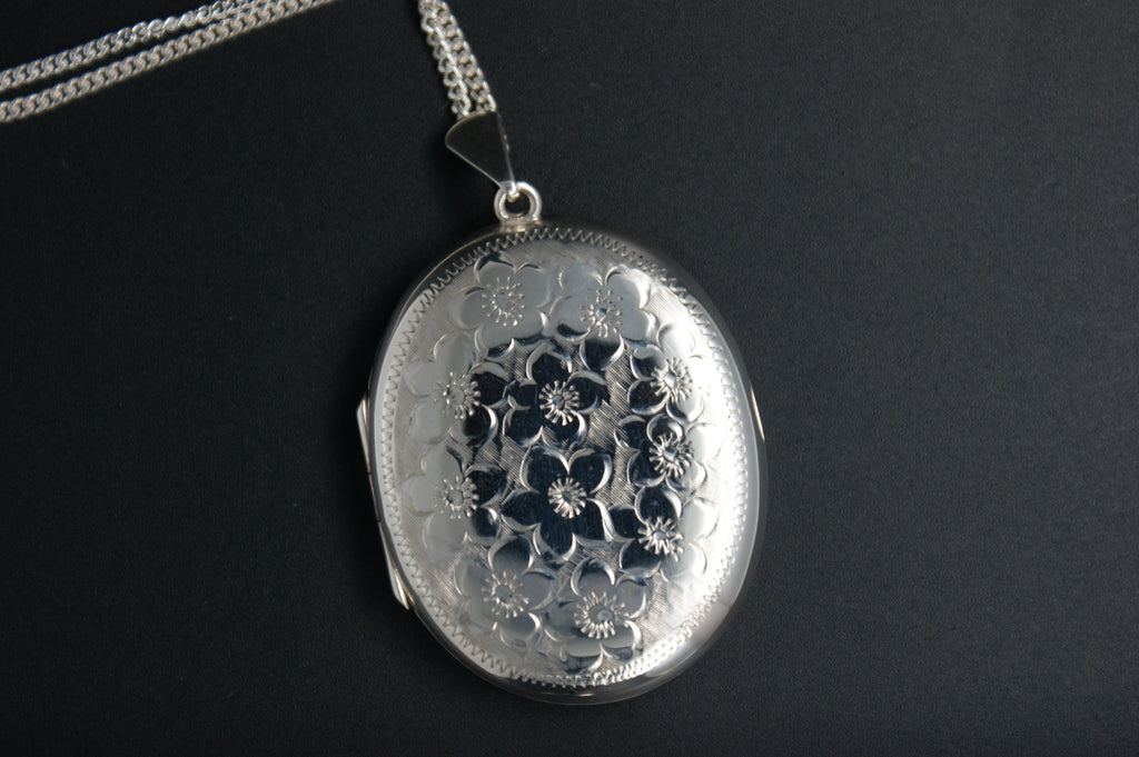 055- Silver oval floral engraved locket