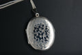 055- Silver oval floral engraved locket