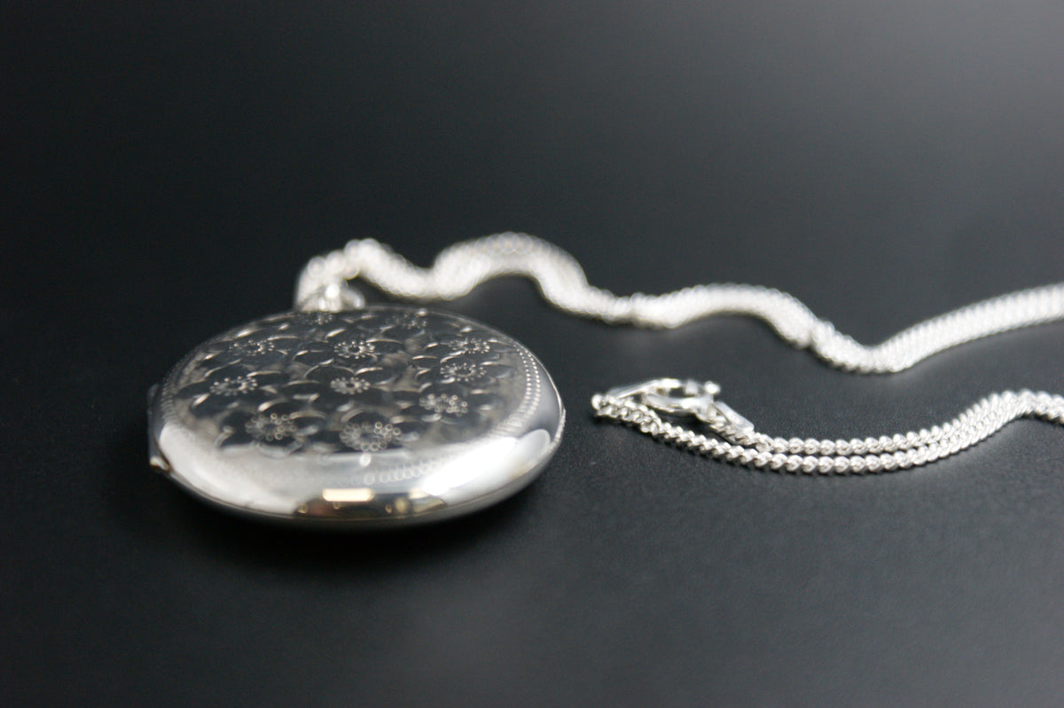 055- Silver oval floral engraved locket