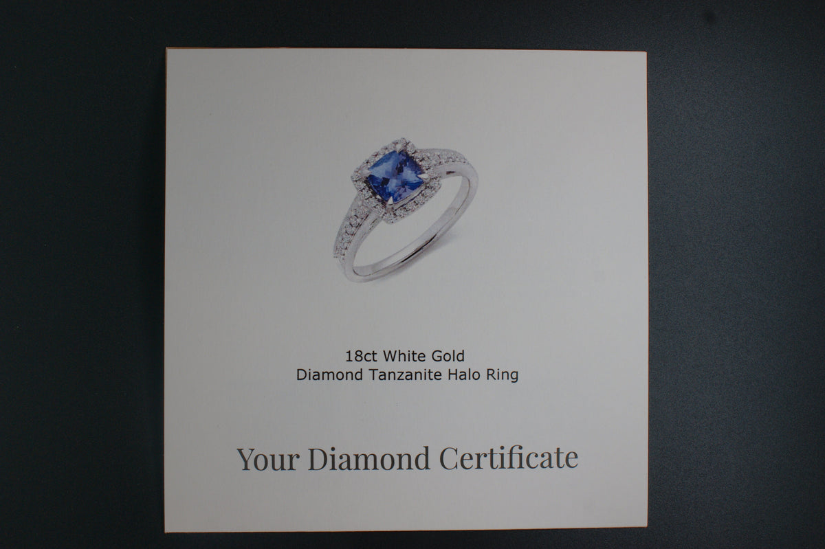 032-18ct White Gold Tanzanite & 0.22ct Diamond Cushion Halo Ring