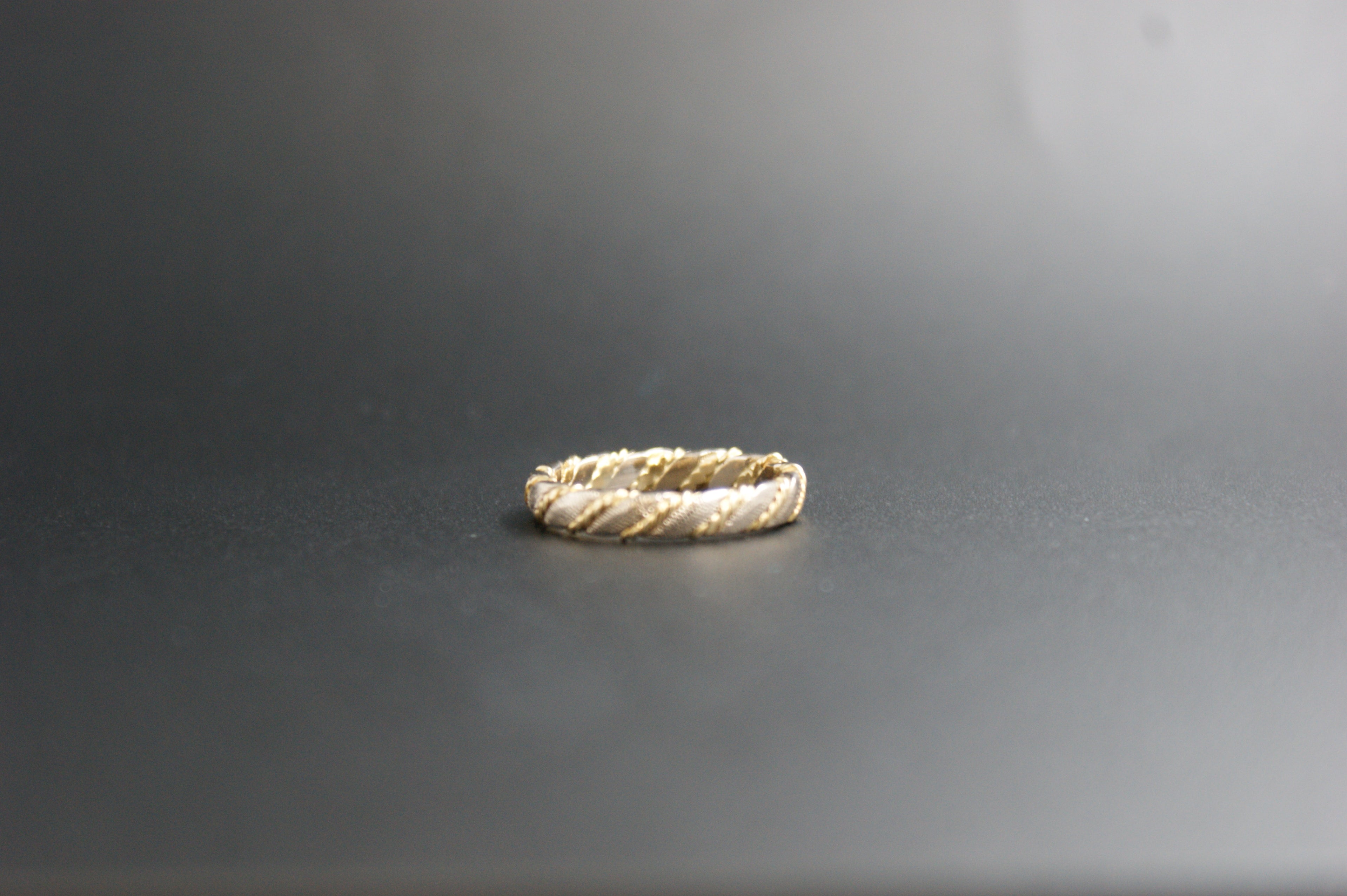0119- 18ct two-toned twisted wedding band.