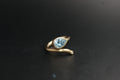 0186- 14ct Yellow Gold Blue Topaz and Diamond Bypass Ring