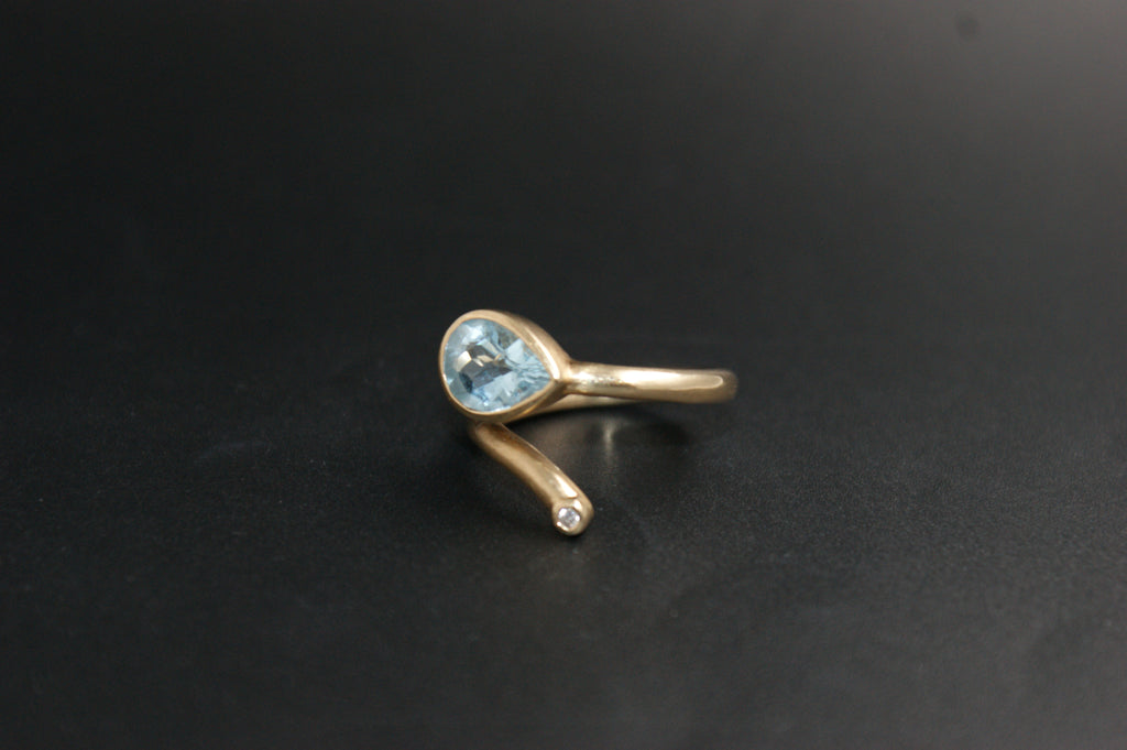 0186- 14ct Yellow Gold Blue Topaz and Diamond Bypass Ring