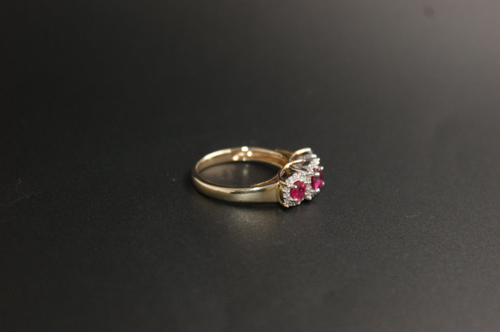 0212- 9ct Gold Three-Stone Ruby and Diamond Halo Ring