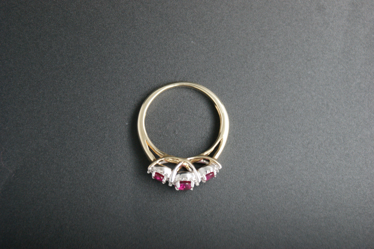 0212- 9ct Gold Three-Stone Ruby and Diamond Halo Ring